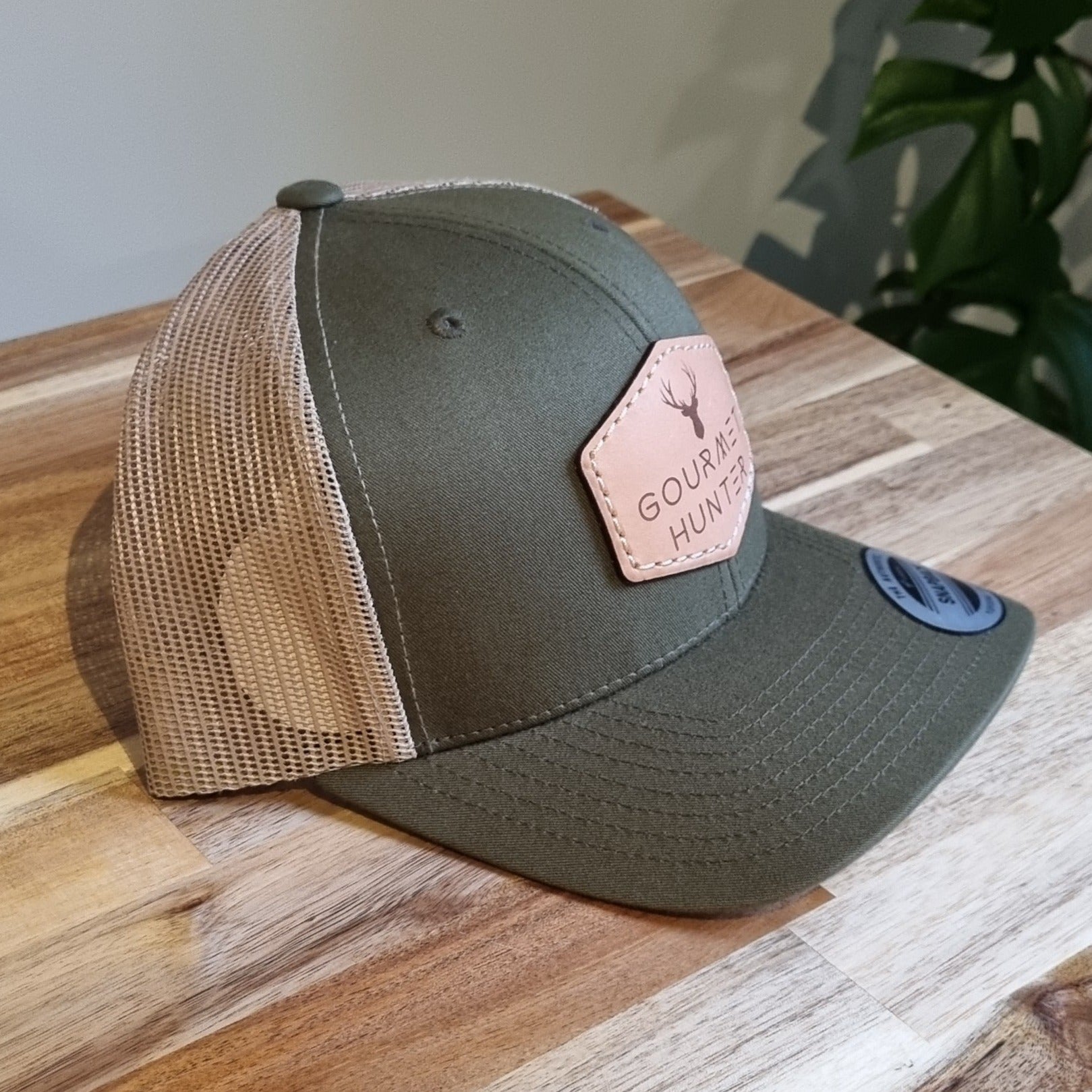 Cooter’s Keep It Between The Ditches Leather Patch Trucker Hat Khaki/Coffee